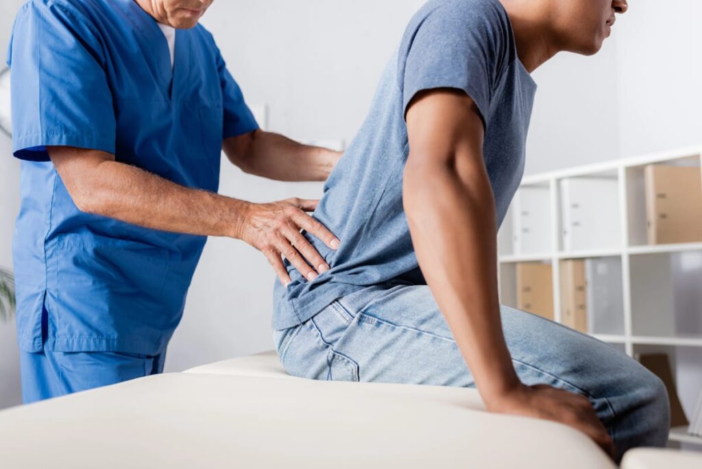 An auto accident chiropractor treats a patient with back pain.