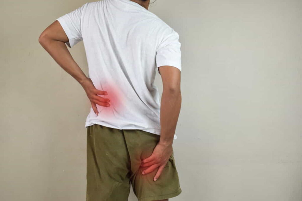 A man with nerve irritation demonstrates where it hurts.