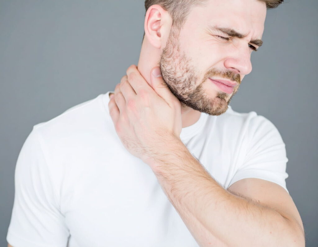 A man holding his neck after an auto accident.