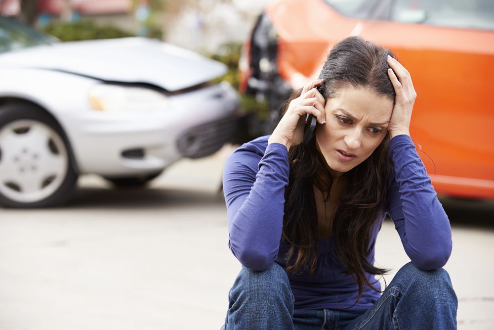 A woman calls her personal injury chiropractor after an auto accident.