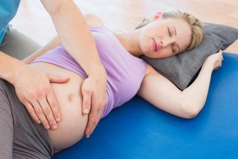 A pregnant woman getting a prenatal massage in Roselle, IL.